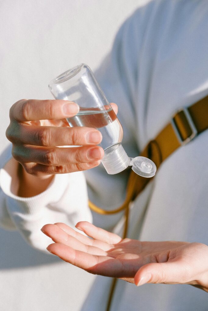 Close-up of a person applying hand sanitizer for hygiene and protection.